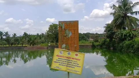 Nebula NP This pond is located in Sobhana’s village in Malappuram district. The health department’s notice says swimming and bathing in the pond are prohibited until further notice. A warning sign board, preventing people from entering the pond, placed in front of Pathiriyal Valiya Pond in Thiruvali grama panchayat in Malappuram district following the death of a woman due to Amoebic Meningoencephalitis.
