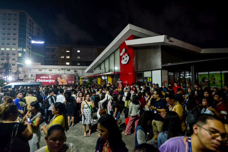 People gather on a street after earthquake tremors at Cebu in central Philippines on September 30, 2025.