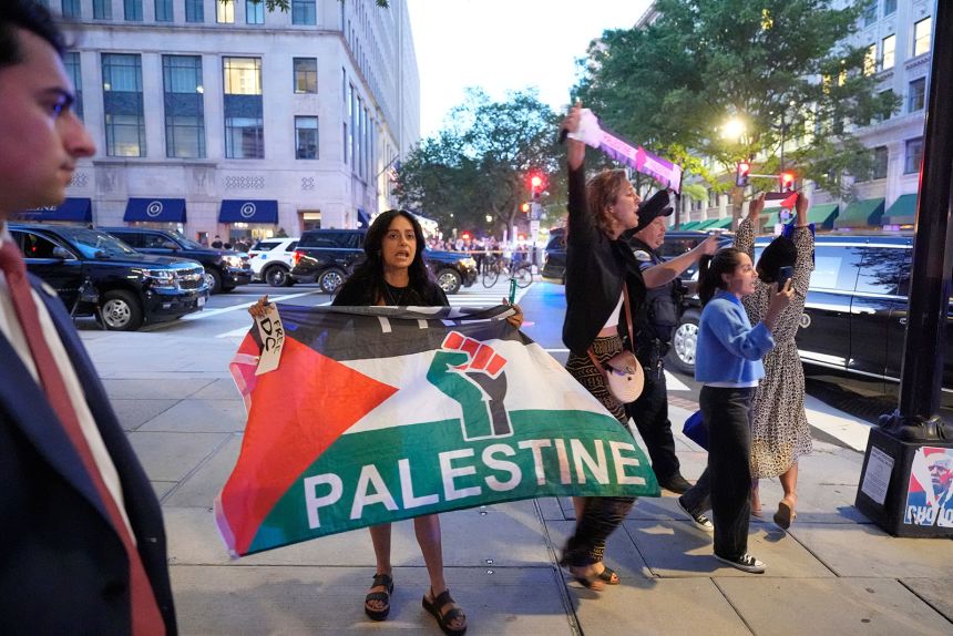 Protesters gather near the restaurant entrance after President Donald Trump arrived for dinner on Tuesday, September 9, in Washington, DC.