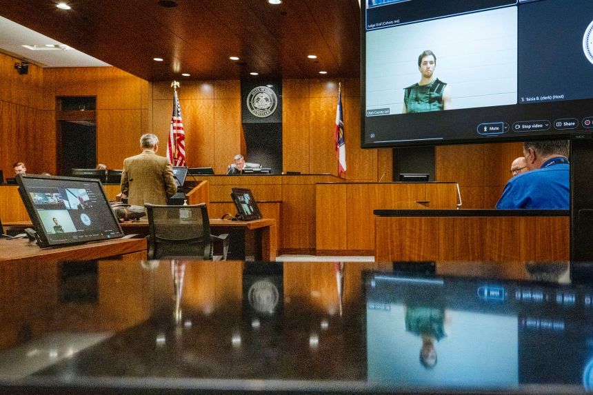 Tyler Robinson, in monitor at right, attended a court hearing virtually from prison on September 16.