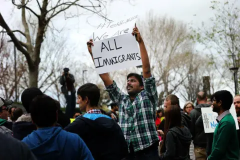 San Francisco Chronicle via Getty Images Muthumalla Dhandapani, an Indian immigrant with an H1-B visa and a Comcast employee in Sunnyvale, protests against President Trump's immigration orders in 2017. A bill in Congress would� alter the employment-based immigrant system, tilting it towards immigrants from India and China, without increasing the overall number of visas for everyone. (Photo by Santiago Mejia/San Francisco Chronicle via Getty Images)