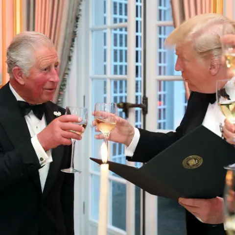 CHRIS JACKSON/AFP via Getty Images Archive photo from 2019: King Charles and President Trump cheers with two wine glasses
