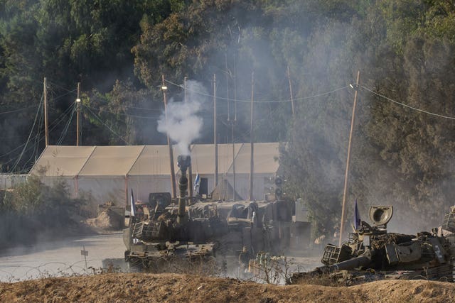 An Israeli mobile artillery unit fires a shell from southern Israel towards the Gaza Strip