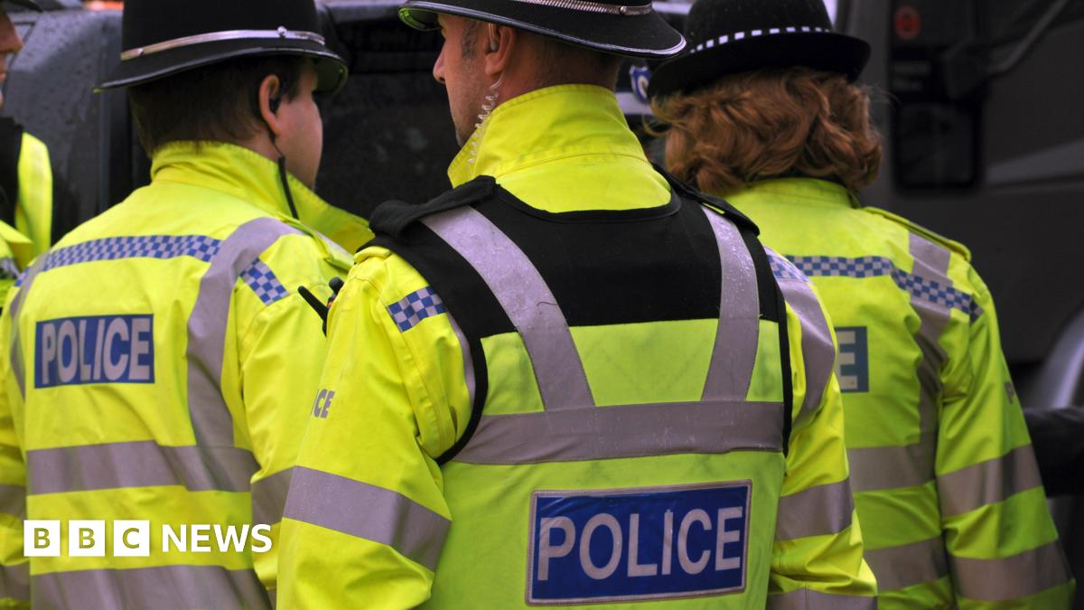 Three police officers in the West Midlands are wearing high-vis jackets.