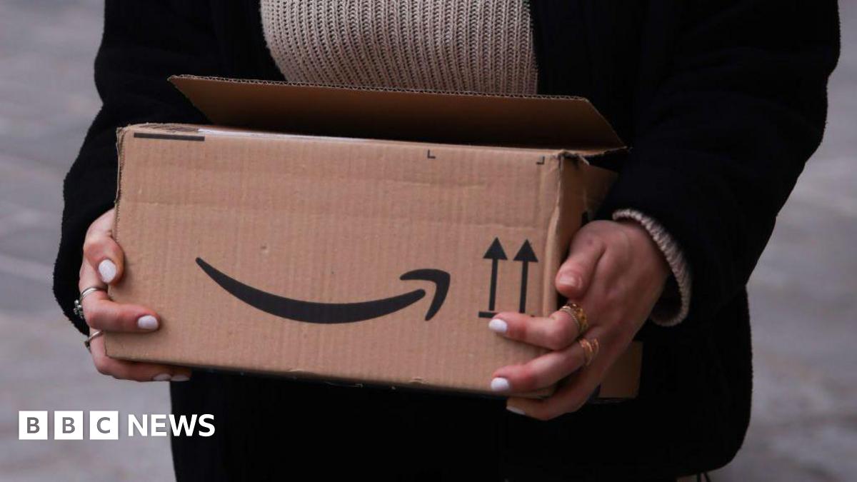 A resident walks with a shovel along a mud-covered road in Hualien on September 24, 2025, following the bursting of a barrier lake during the passing of Super Typhoon Ragasa.