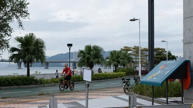 A man cycling in Hong Kong