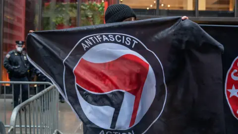 Getty Images A logo featuring black and red flags is widely associated with Antifa  