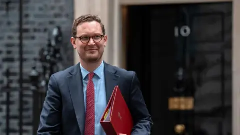 AFP via Getty Images Darren Jones in Downing Street, with the No 10 door behind him