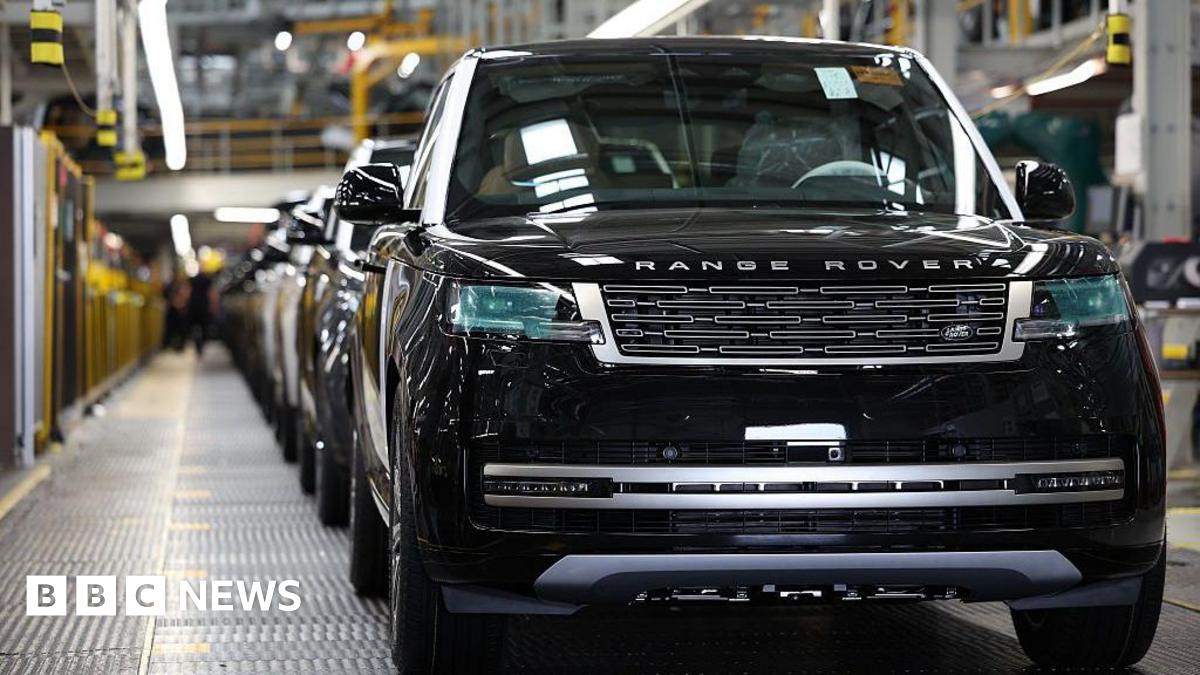 A black Range Rover on a car production line