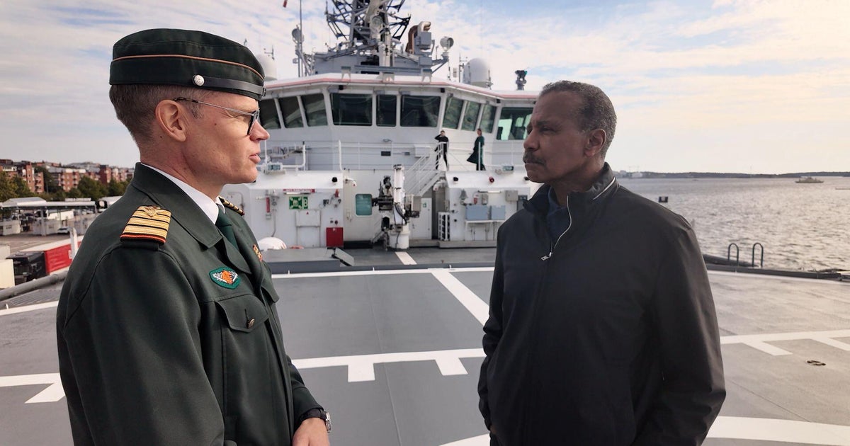 Coast Guard Cmdr. Mikko Simola and Bill Whitaker