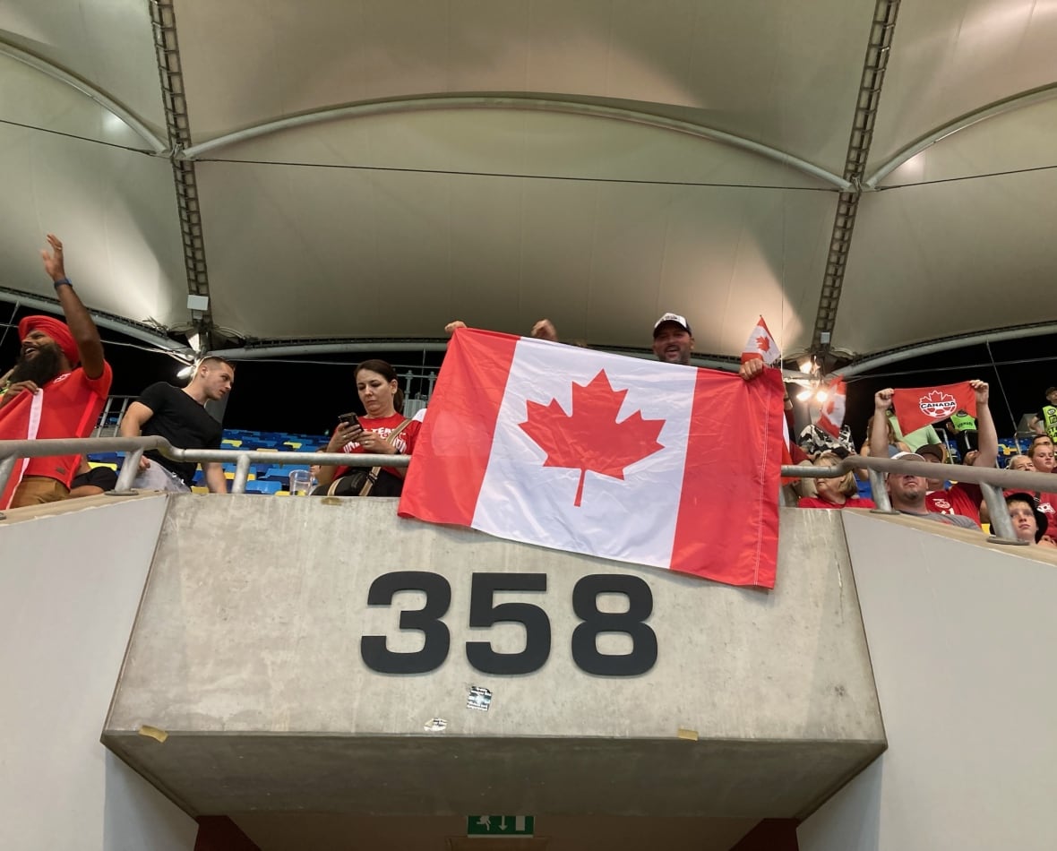 A man waves a Canadian flag.