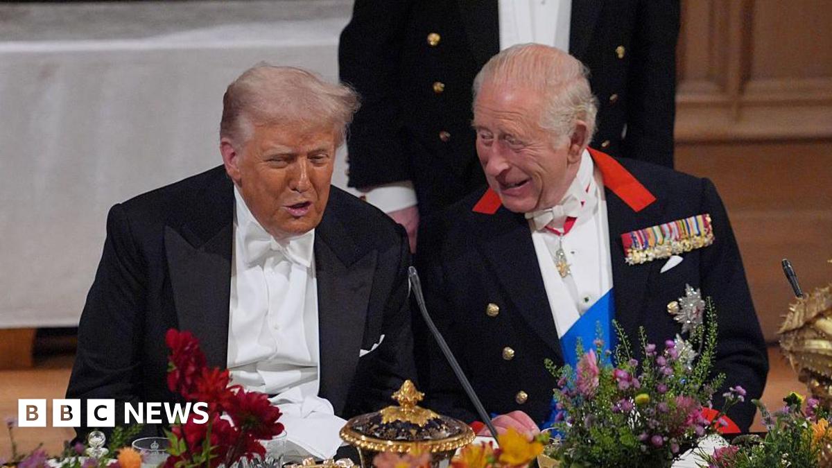 President Trump, wearing a tuxedo, sitting alongside King Charles at a banquet table at Windsor Castle.