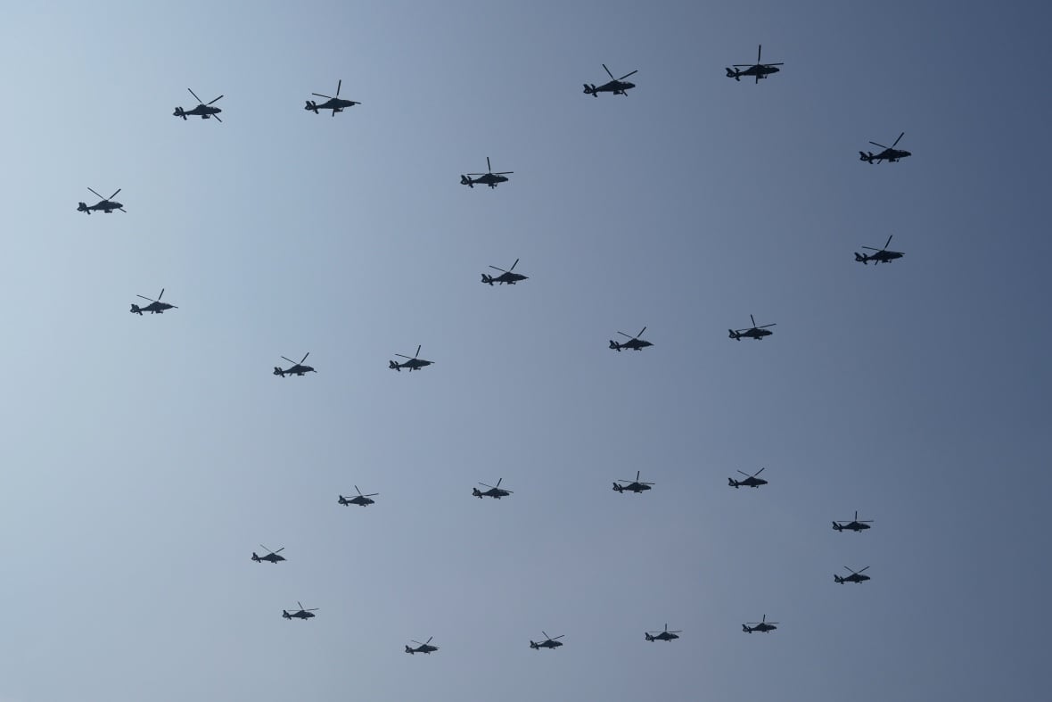 Helicopters form the number 80 while they fly in the air.