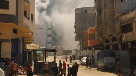 Reuters Smoke billows from an evacuated UNRWA school following Israeli airstrikes, at al-Shati (Beach) refugee camp, in Gaza City, September 13