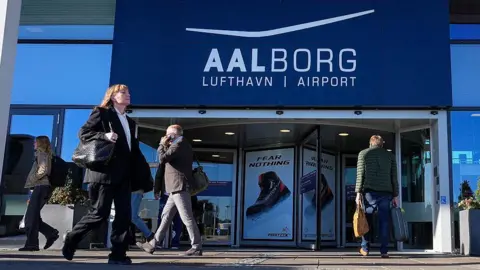 BO AMSTRUP/Ritzau Scanpix/AFP Passengers walked in front of the terminal in Aalborg