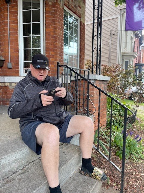 Dan Myles sits on his front steps in Hamilton.