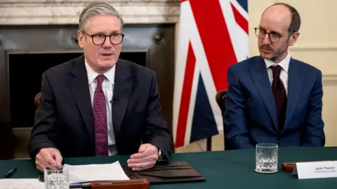 Getty Images British Prime Minister Keir Starmer holds a roundtable meeting with writer Jack Thorne (R) at Number 10 Downing Street on March 31, 2025 in London, 