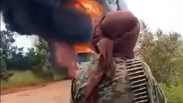 A grab from the verified video shows a fighter watching as lorry burns