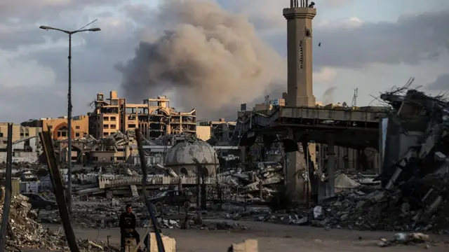 Smoke rises from rubble of residential buildings in Gaza City