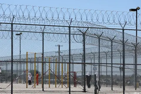 AFP via Getty Images People detained are seen behind fences at the Desert View Annex at the private prison company GEO Group Adelanto ICE Processing Center detention facility in Adelanto, California on July 10, 2025. Donald Trump's promise to carry out the largest deportation operation in US history has appalled some Americans. 