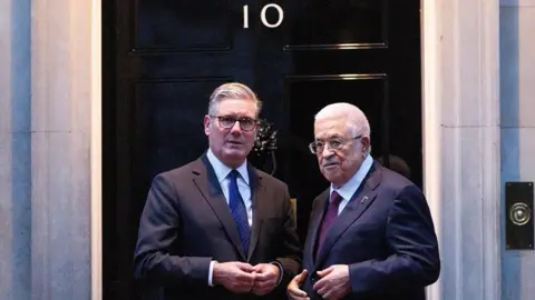 EPA/Shutterstock Sir Keir Starmer and Palestinian Authority president Mahmoud Abbas pose for a picture outside the door to 10 Downing Street