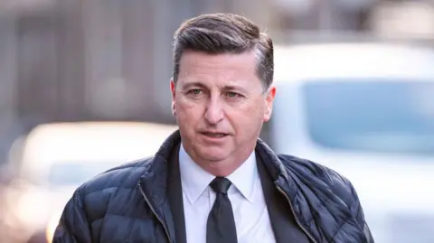 Getty Images Douglas alexander walking in suit