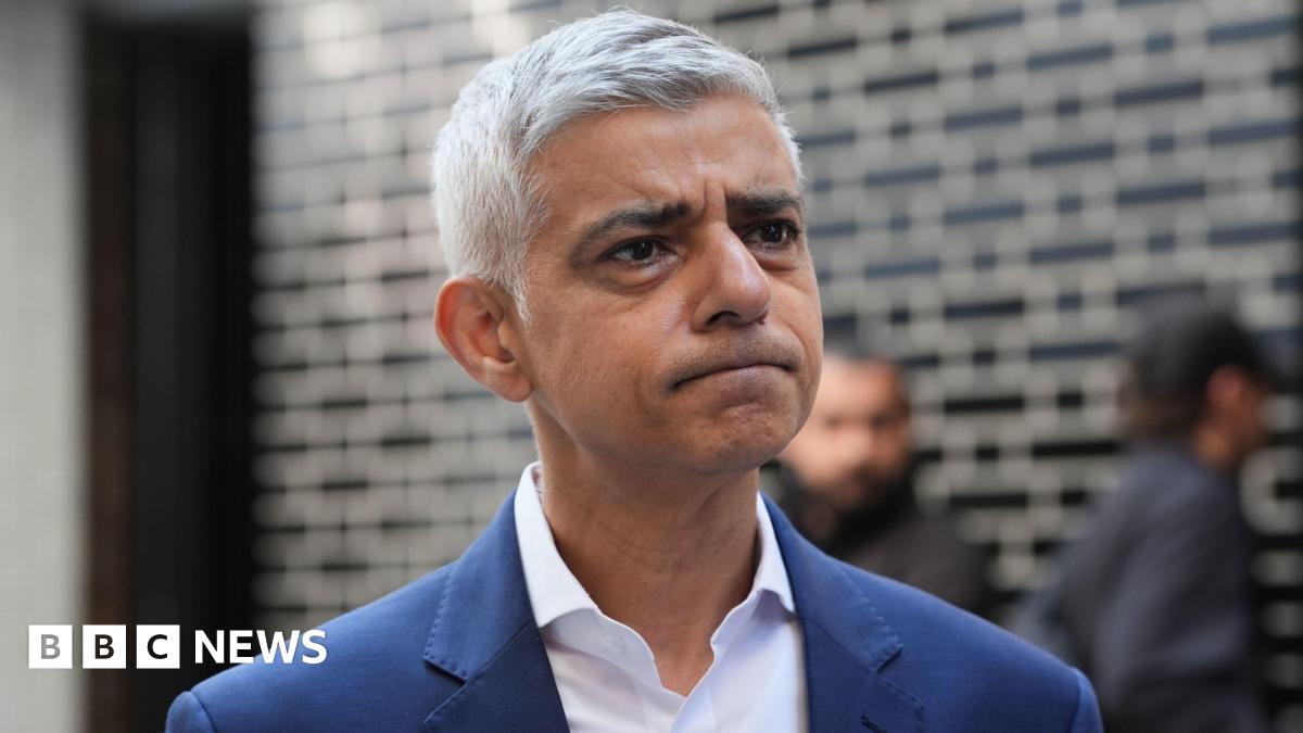 Sadiq Khan in white shirt and blue jacket