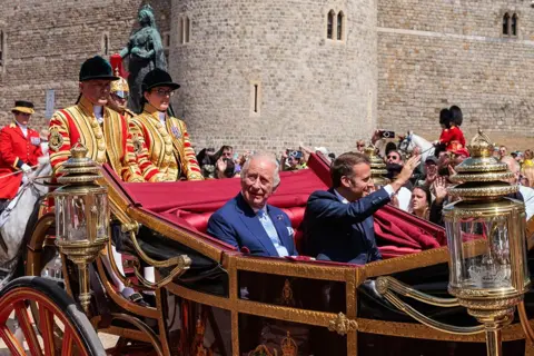 Mark Kerrison/In Pictures via Getty Images King Charles III and President Emmanuel Macron of France proceed by carriage to Windsor Castle on the first day of the latter's State Visit to the UK on 8th July 2025 in Windsor, United Kingd