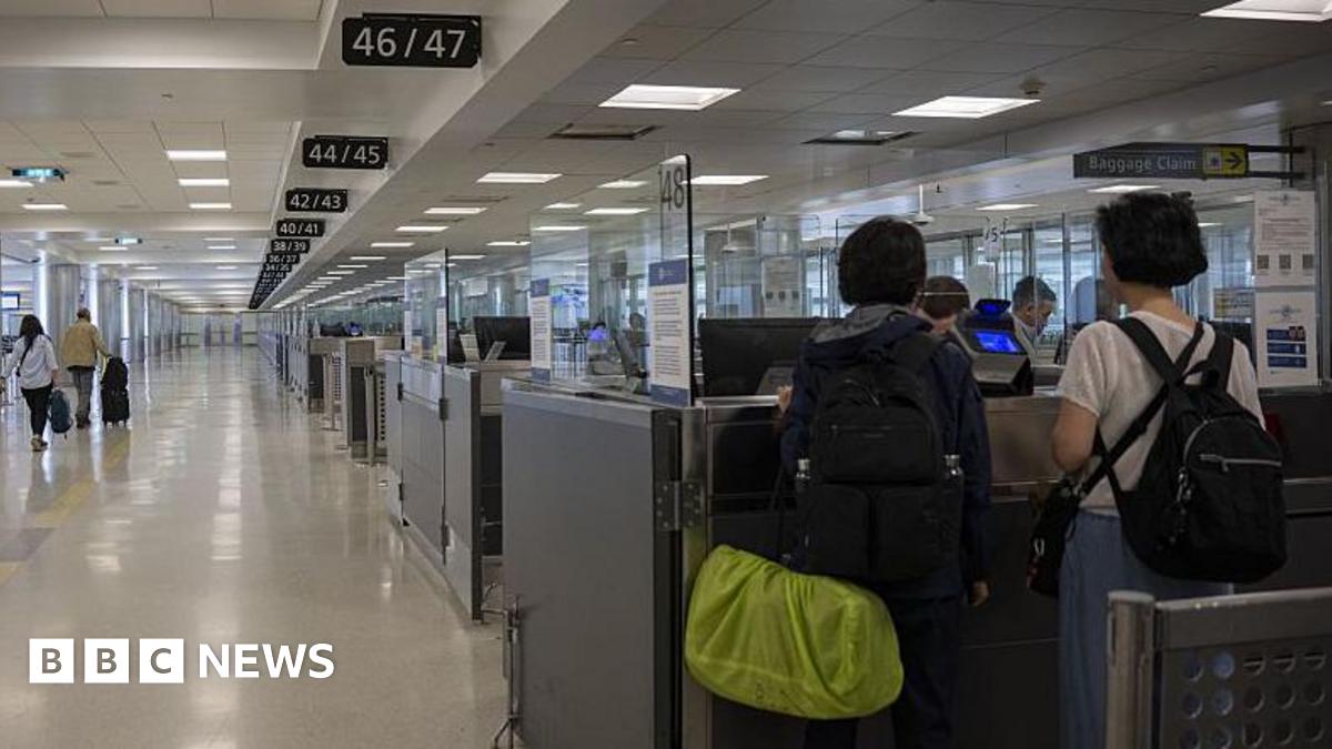 Two people have their passports checked at a US international airport
