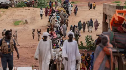 Reuters Sudanese people, who fled the conflict in Murnei in Sudan's Darfur region, cross the border between Sudan and Chad in Adre, Chad.
