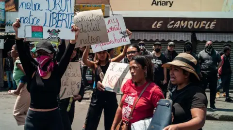 EPA/Shutterstock Women holding signs at the protest