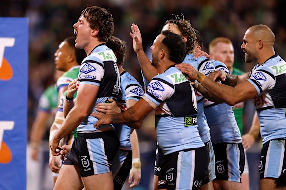 The Sharks celebrate a try. 