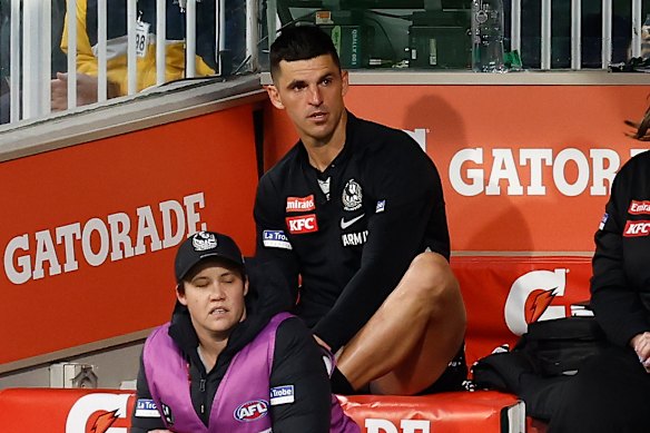 Scott Pendlebury of the Magpies takes his place on the bench.
