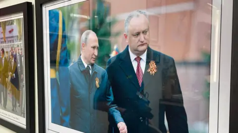 A framed photo of Vladimir Putin with Igor Dodon