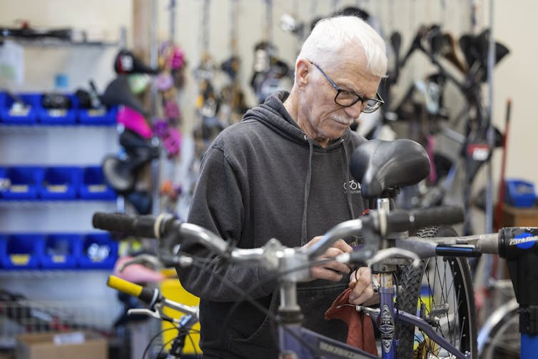 A man fixes a bicycle.