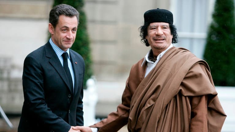 French President Nicolas Sarkozy, left, greets Libyan leader Col Moammar Gadhafi upon his arrival on December 10 2007 at the Elysee Palace