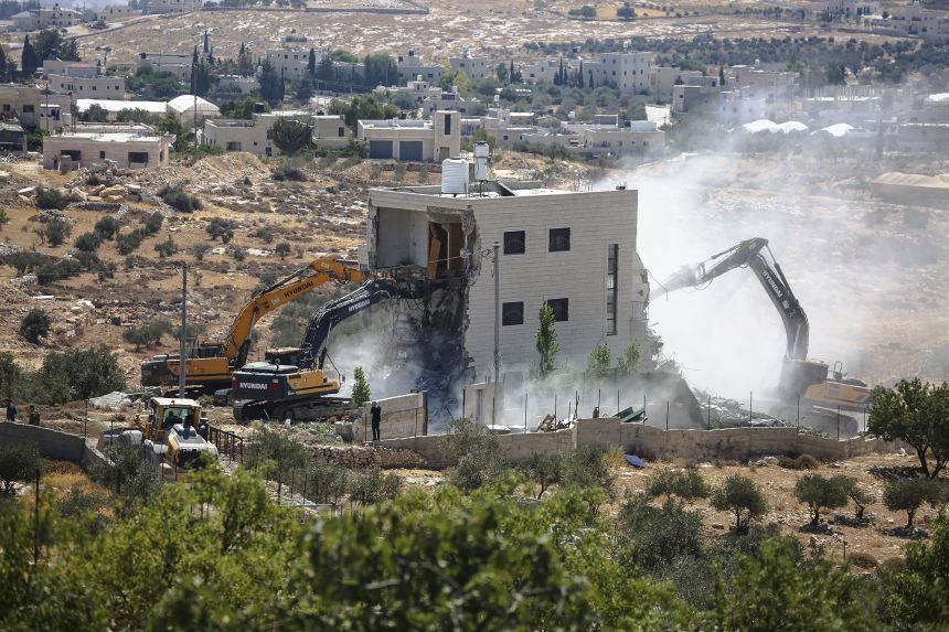 Israeli bulldozers demolish a Palestinian house in the village of Marah Ma'ala, south of Bethlehem in the occupied West Bank, July 13, 2025.