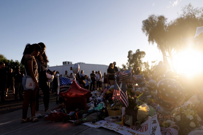People visit a memorial for Charlie Kirk at the Turning Point USA headquarters on September 12, in Phoenix.