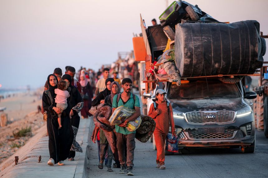 Displaced Palestinians evacuating southbound from Gaza City travel along a coastal road in Nuseirat in the central Gaza Strip on September 13, 2025.