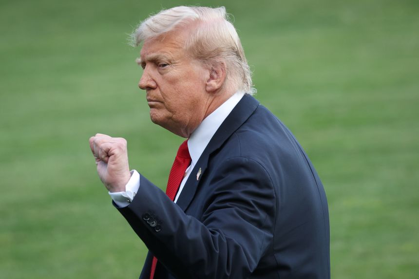 President Donald pumps his fist after taking questions from reporters on killed conservative activist Charlie Kirk, while departing the White House on September 11.