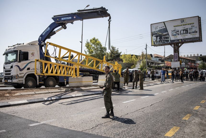 Israeli security forces set up an iron gate at the entrance of al-Ayzariyah town in the occupied West Bank on September 16, 2025.