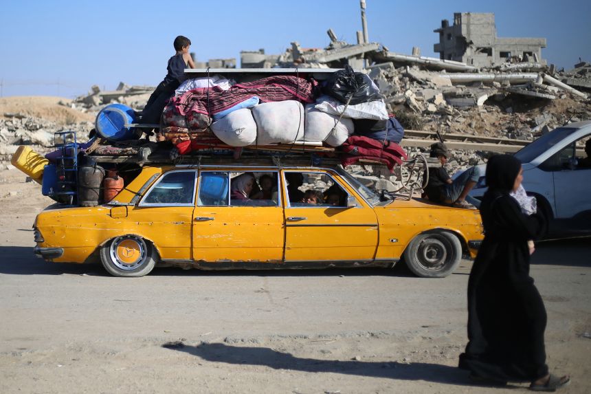 Displaced Palestinians move southward with their belongings on a road in the Nuseirat refugee camp in the central Gaza Strip following renewed Israeli evacuation orders for Gaza City on September 16.