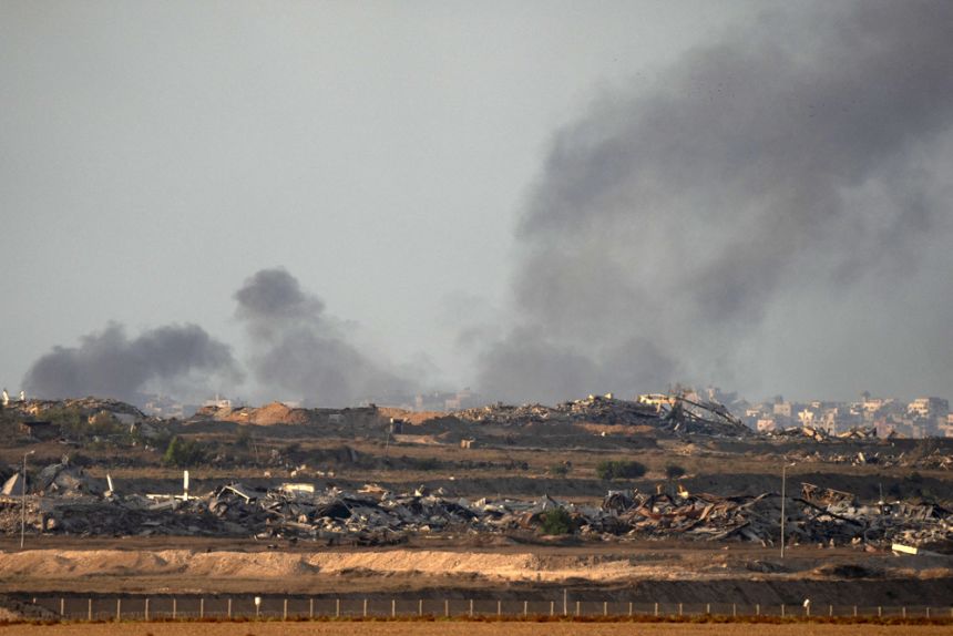 In this picture taken from the Israeli border with Gaza, smoke rises over destroyed buildings in the besieged Palestinian territory on Thursday, September 18. Israeli tanks and jets pounded Gaza City, the target of a major ground offensive, on September 18 prompting Palestinians to flee south.