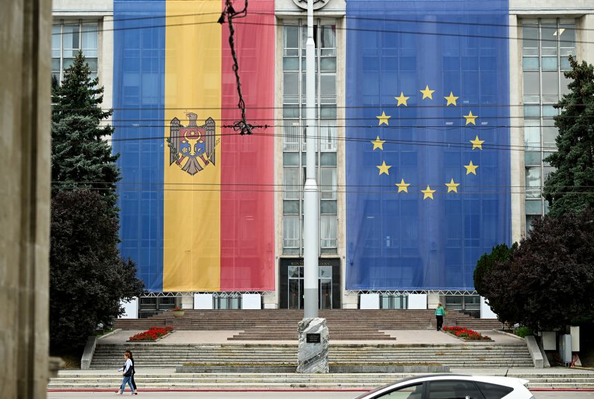 Moldovan and European Union flags fly in front of Government House in Chisinau.