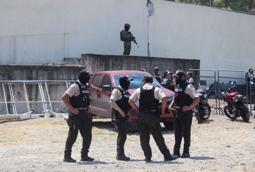 Police officers stand guard in front of the prison in Esmeraldas on Thursday.