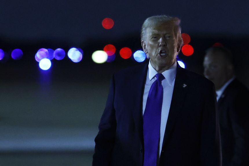 President Trump speaks to reporters at Joint Base Andrews while returning to the nation's capital Tuesday.
