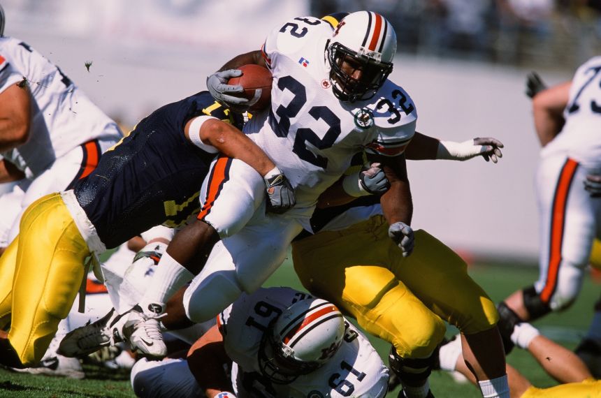 Auburn's Rudi Johnson runs with the ball against Michigan in 2001.
