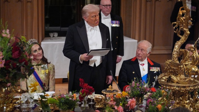 US President Donald Trump delivers a speech at a banquet table as King Charles III and Catherine, Princess of Wales, listen.