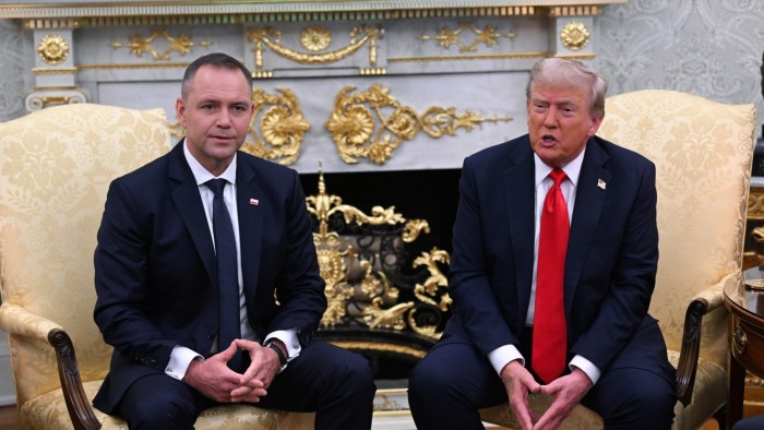 Karol Nawrocki and Donald J. Trump seated side by side in formal attire during a meeting at the White House.