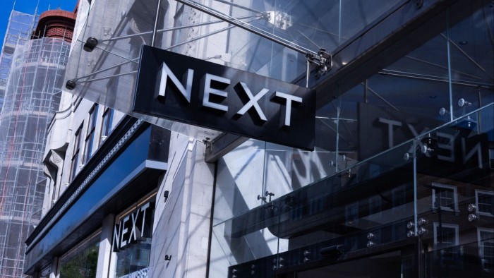 A Next sign above the entrance of a store in Oxford Street, London